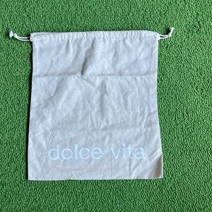 Dolce Vita dust bag. 13.5 by 15 inches. Draw strap. Beige with white letters.